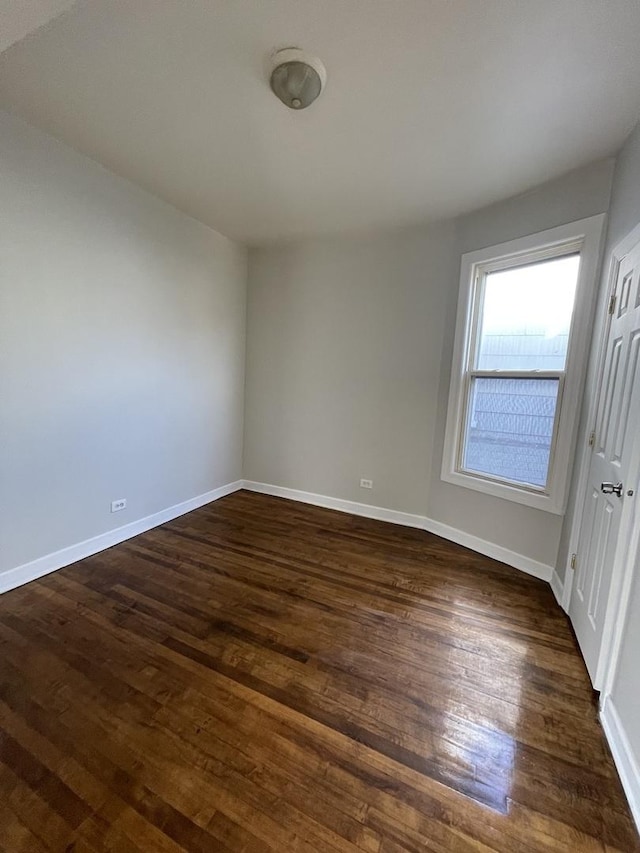 spare room featuring dark hardwood / wood-style flooring