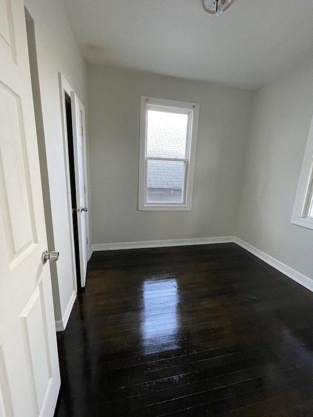 unfurnished room featuring dark hardwood / wood-style floors