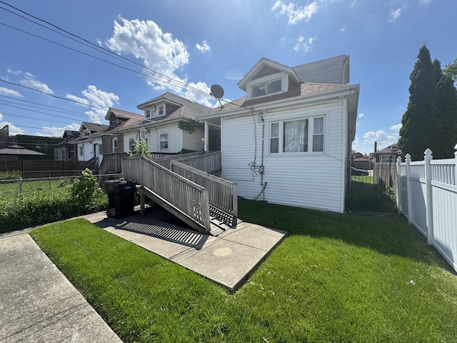 back of house featuring a yard and a patio