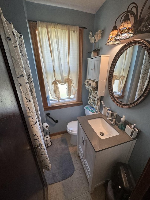 bathroom featuring tile patterned floors, vanity, and toilet