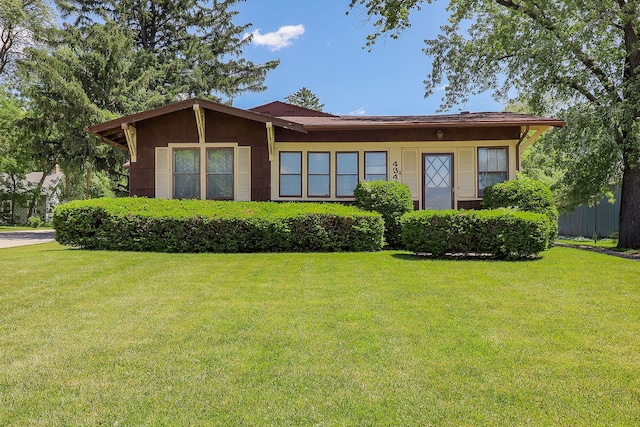 ranch-style home featuring a front yard