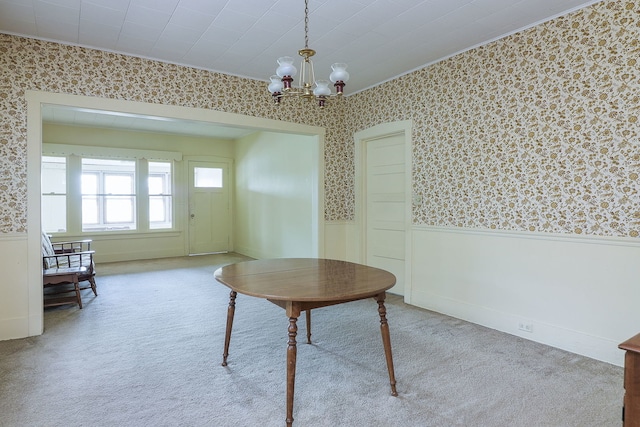 unfurnished office featuring an inviting chandelier and light colored carpet