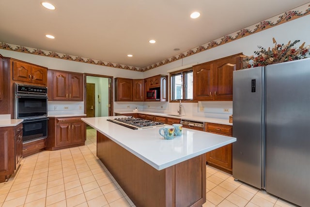 kitchen with light tile patterned floors, sink, a kitchen island, and black appliances