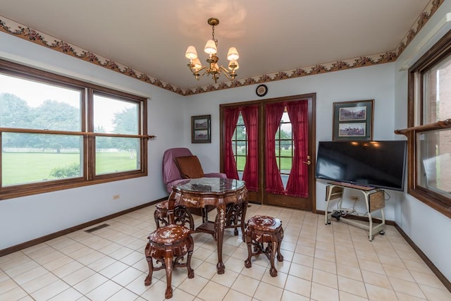 tiled dining area featuring a chandelier