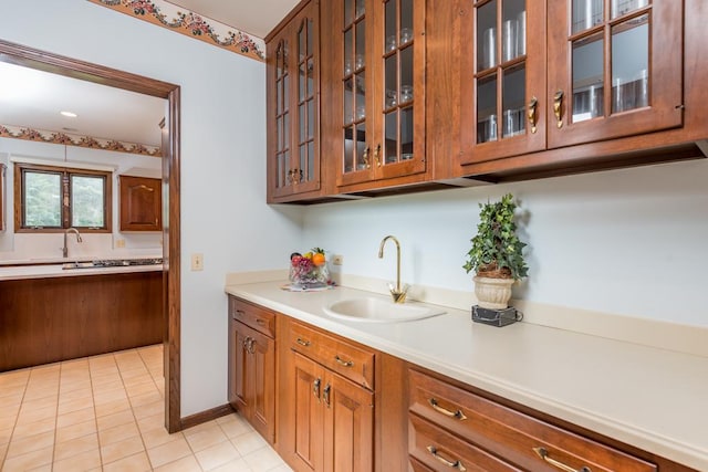 kitchen featuring light tile patterned floors and sink