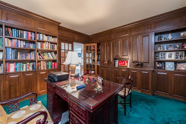 carpeted home office with built in features and wooden walls