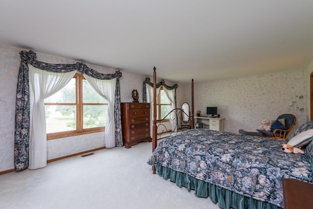 bedroom featuring carpet floors and multiple windows