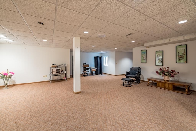 basement featuring carpet and a paneled ceiling