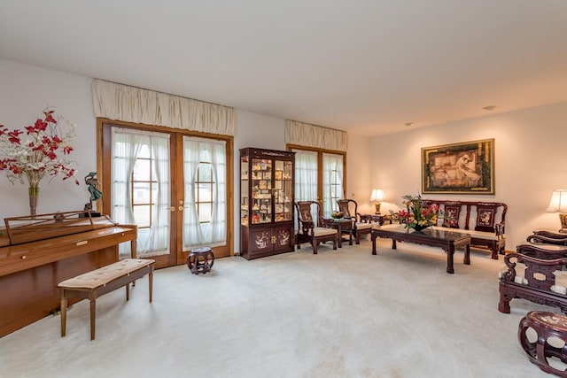 sitting room featuring french doors and carpet floors