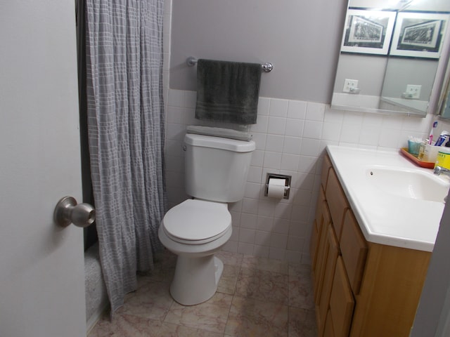 bathroom featuring toilet, tile patterned floors, backsplash, tile walls, and vanity