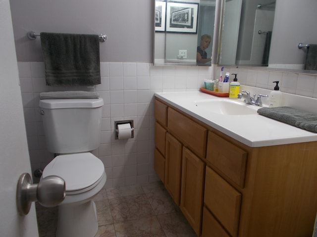 bathroom featuring tile patterned floors, tasteful backsplash, tile walls, and toilet