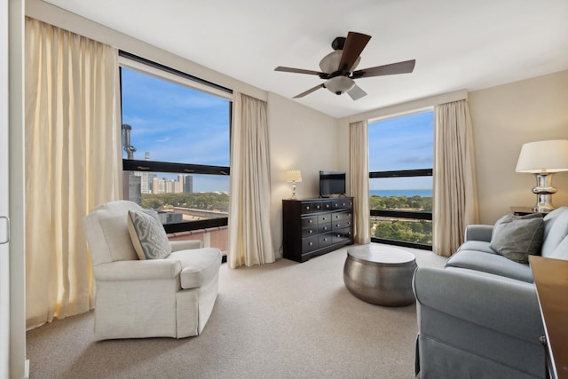 carpeted living room featuring ceiling fan