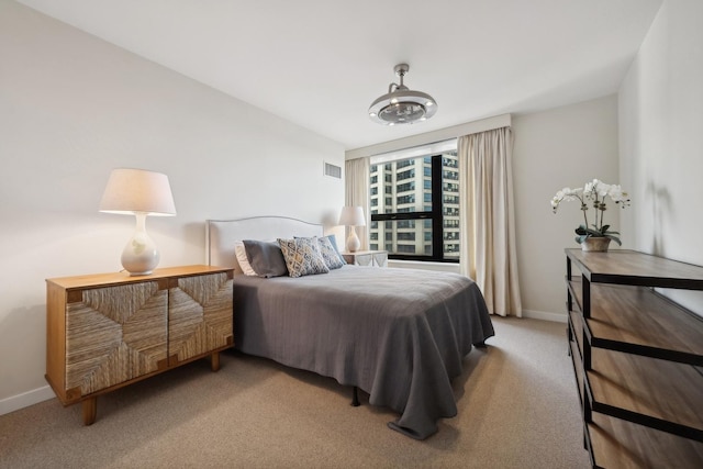 bedroom featuring light carpet