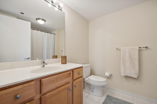 bathroom with vanity, tile patterned floors, and toilet