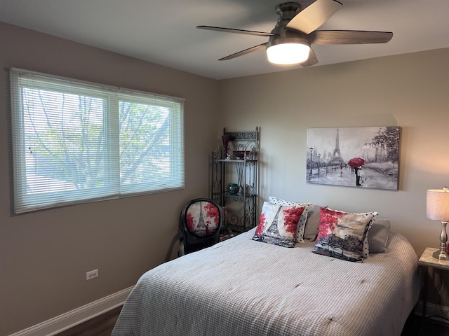 bedroom featuring baseboards, ceiling fan, and wood finished floors