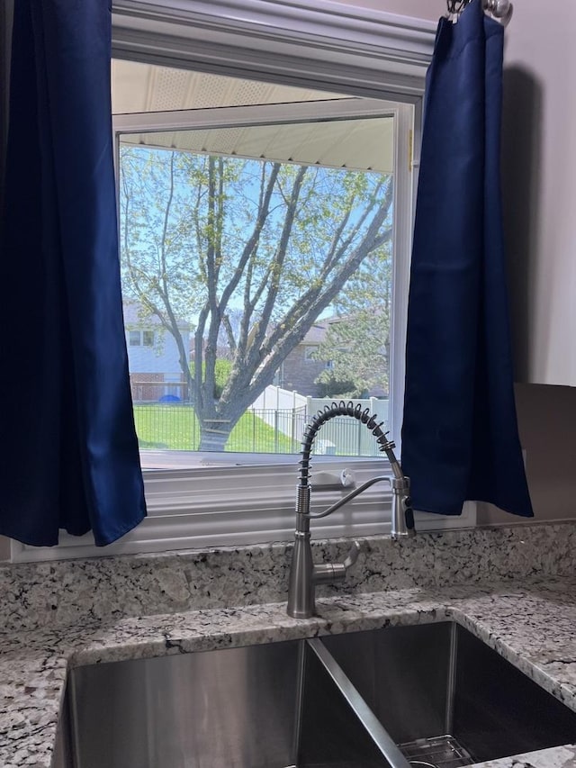 details with light stone counters and a sink