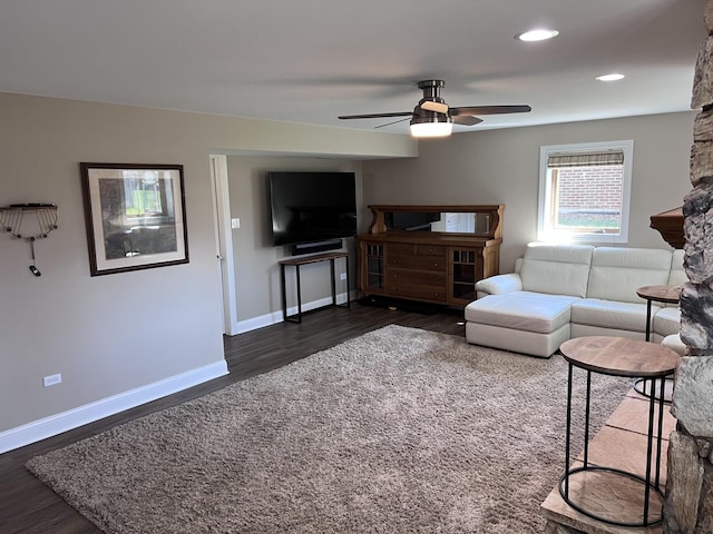 living area featuring baseboards, a ceiling fan, dark wood-style flooring, and recessed lighting