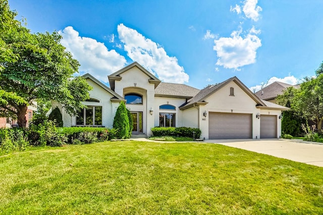 view of front of property with a garage and a front yard