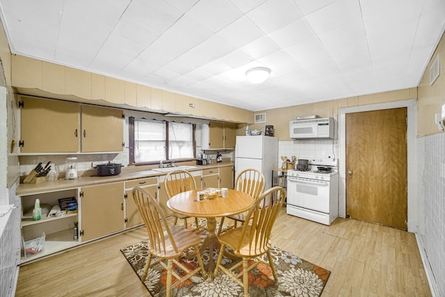 dining area featuring sink and light hardwood / wood-style flooring