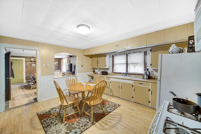 dining area featuring sink and light hardwood / wood-style flooring