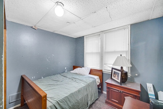 carpeted bedroom featuring a paneled ceiling