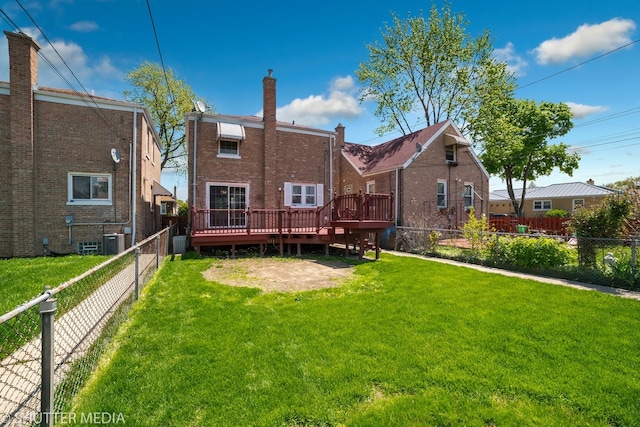 back of property with central air condition unit, a wooden deck, and a lawn