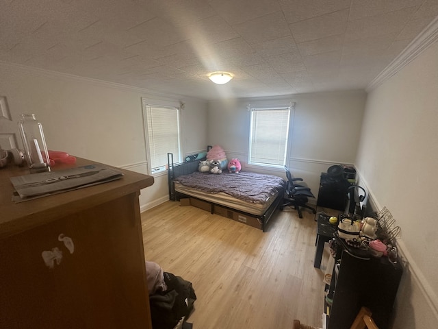 bedroom featuring wood-type flooring and crown molding