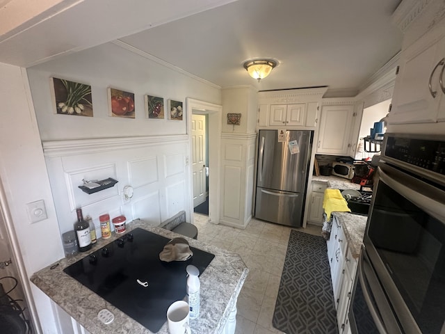 kitchen featuring white cabinets, crown molding, and appliances with stainless steel finishes