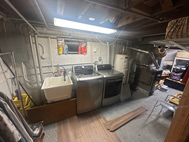 washroom with heating unit, water heater, washer and clothes dryer, and sink