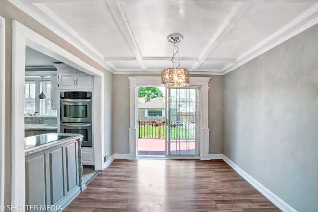 doorway to outside featuring sink, dark wood-type flooring, coffered ceiling, beamed ceiling, and a chandelier