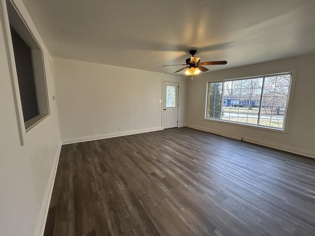 empty room with dark hardwood / wood-style floors and ceiling fan