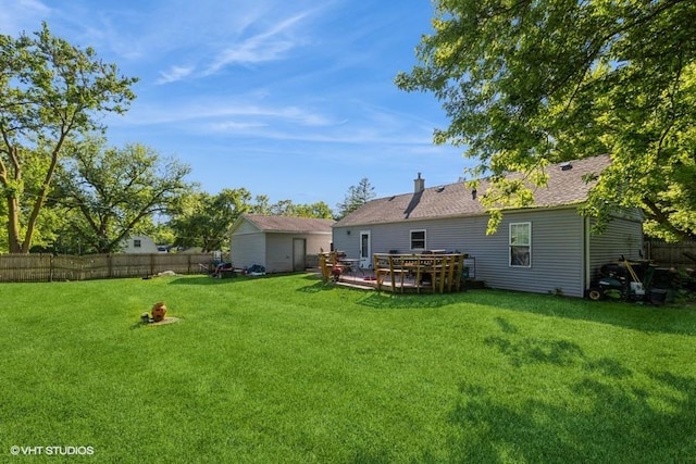 back of property featuring a yard and a deck