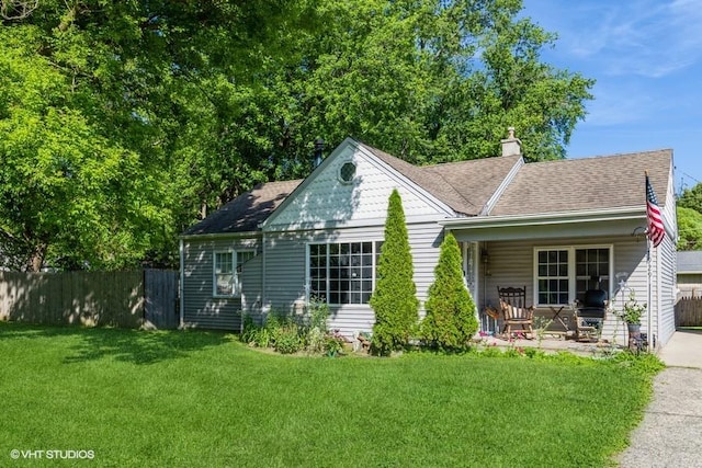 back of house with a yard and a porch