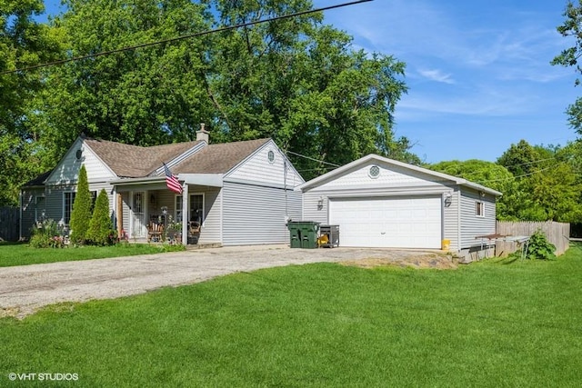 view of front of property featuring covered porch, a garage, and a front yard