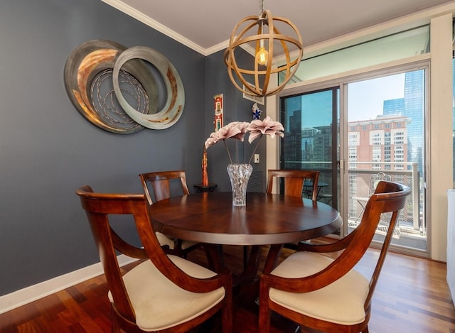 dining room featuring crown molding, a chandelier, and hardwood / wood-style flooring