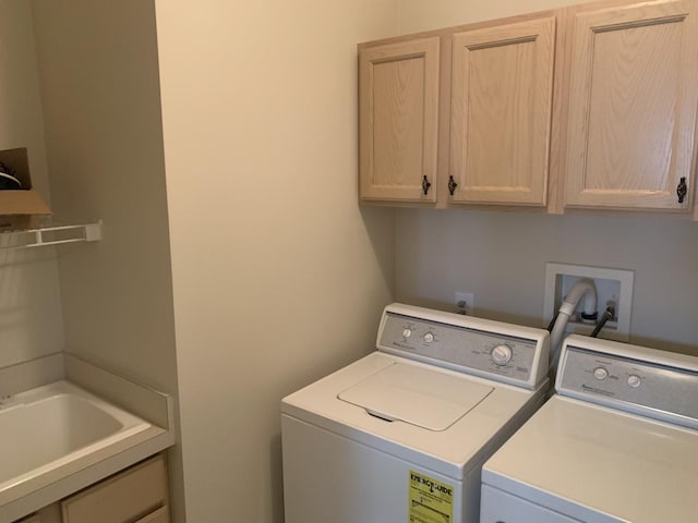 laundry room with cabinets and washing machine and clothes dryer