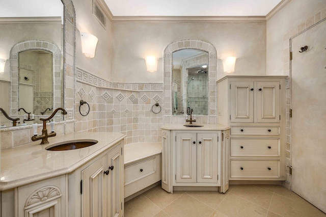 bathroom featuring a tile shower, tile walls, vanity, ornamental molding, and tile patterned floors