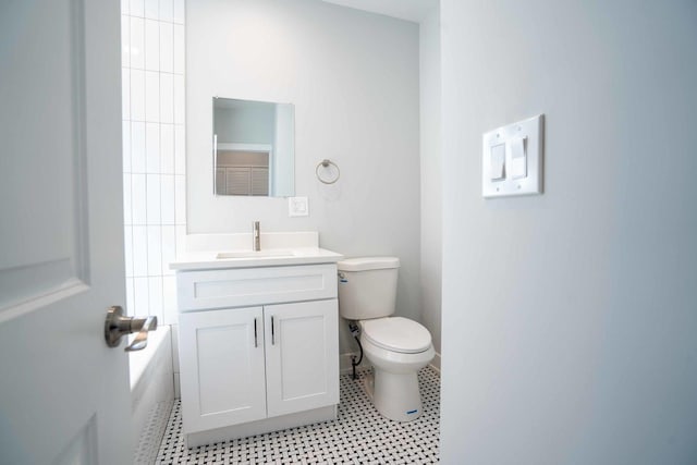 bathroom with tile patterned flooring, vanity, and toilet