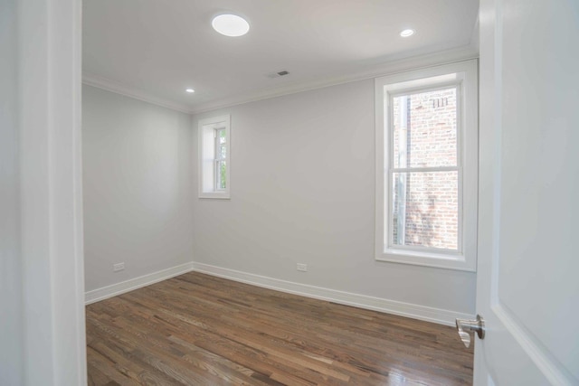 unfurnished room with dark wood-type flooring and ornamental molding