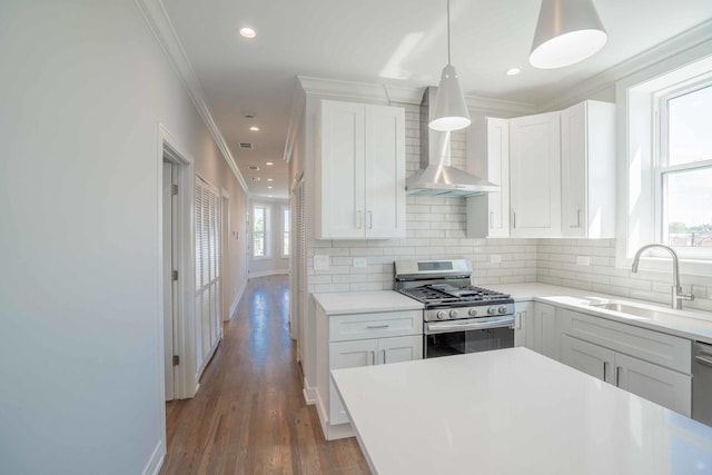 kitchen with sink, white cabinets, plenty of natural light, and appliances with stainless steel finishes