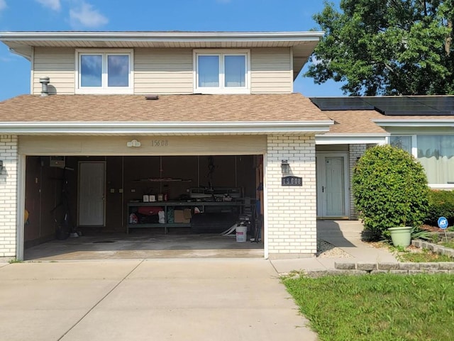 view of front of property with solar panels and a garage