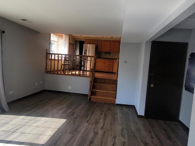 unfurnished living room with dark hardwood / wood-style flooring