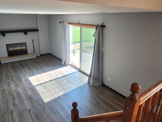 unfurnished living room featuring wood-type flooring and lofted ceiling