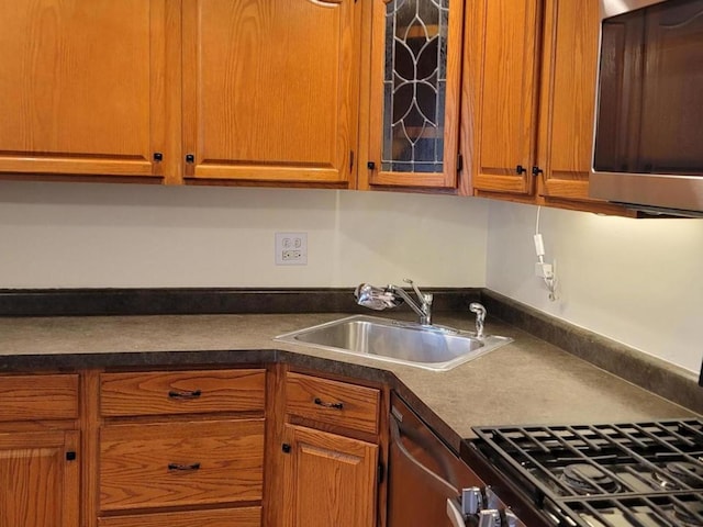 kitchen featuring dishwasher, range, and sink