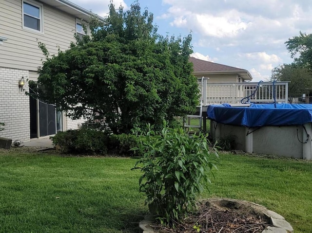 view of yard with a covered pool and an outdoor fire pit