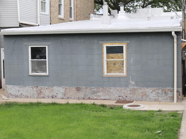 view of side of property with a lawn