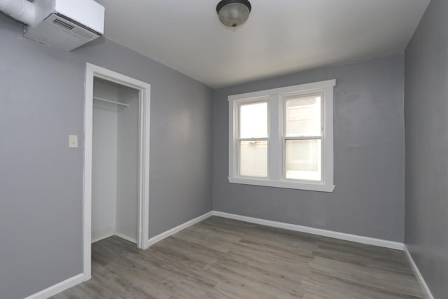 unfurnished bedroom featuring light wood-type flooring and a closet