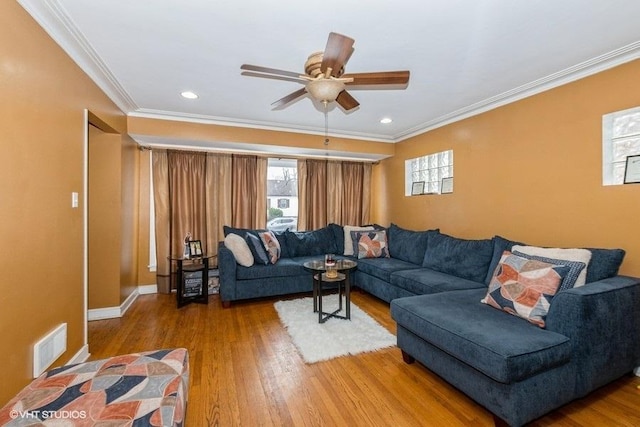 living room with crown molding, hardwood / wood-style floors, and ceiling fan