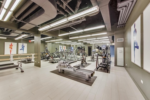 exercise room featuring hardwood / wood-style floors