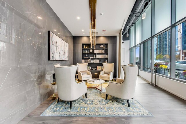 sitting room featuring hardwood / wood-style floors, a wealth of natural light, and a barn door